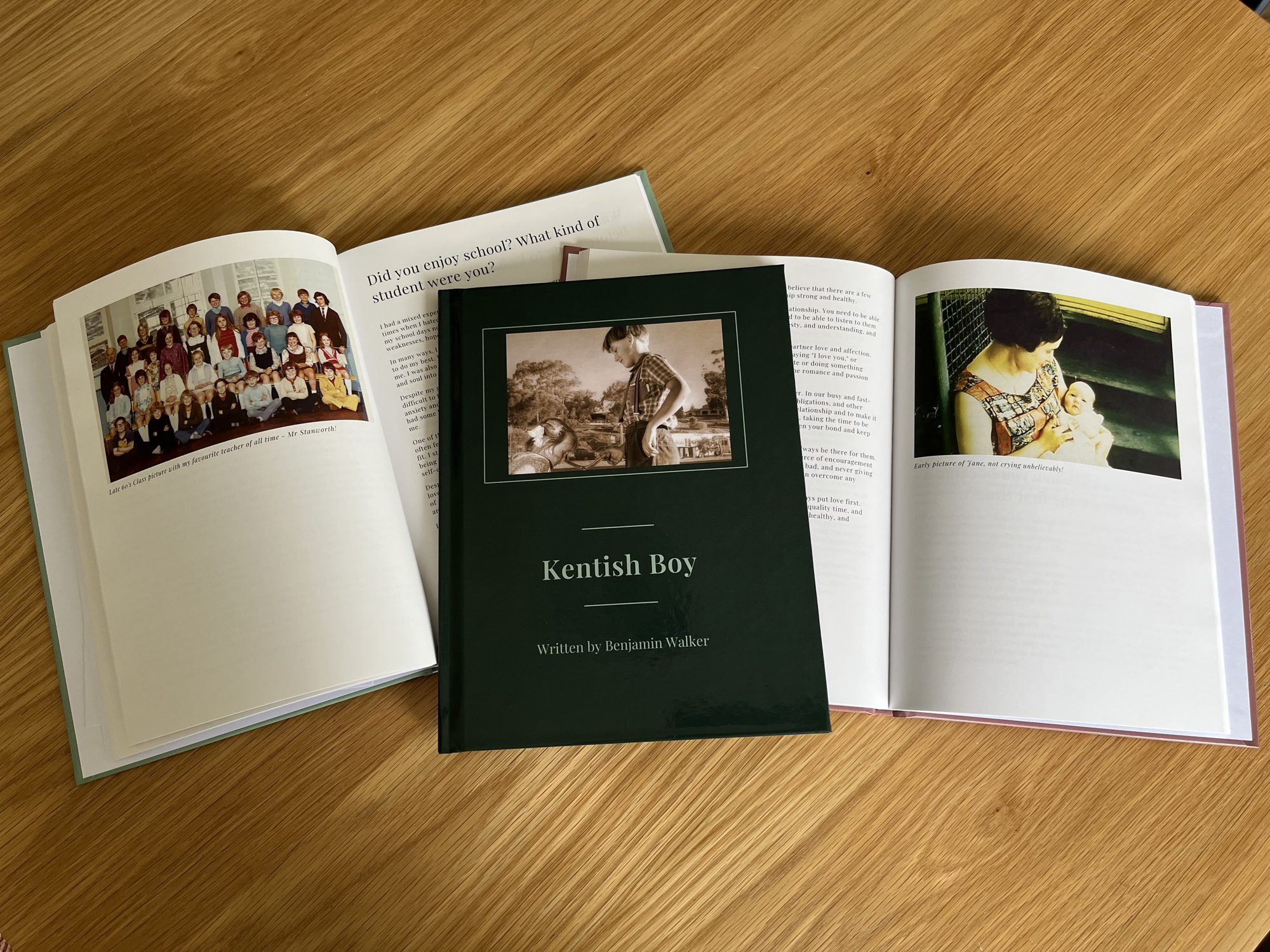 A finished YourStory hardback, Kentish Boy, between two open books showing family photos and written stories